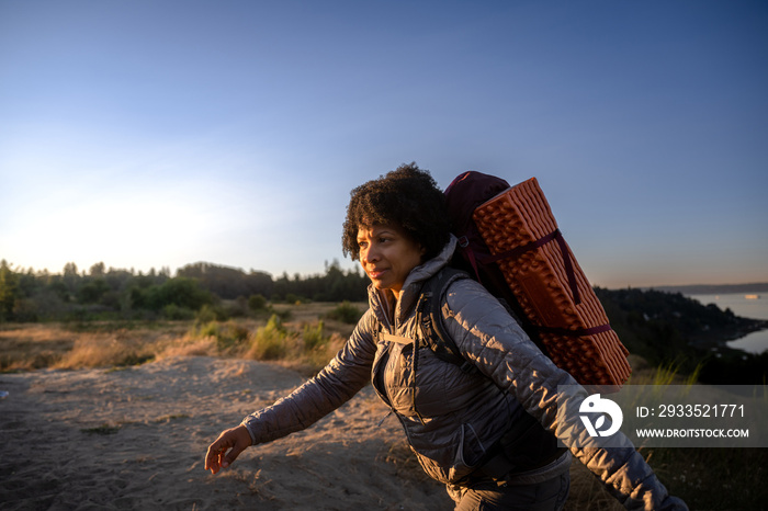 U.S. Army female soldier putting in the miles with an early morning hike in the NorthWest.