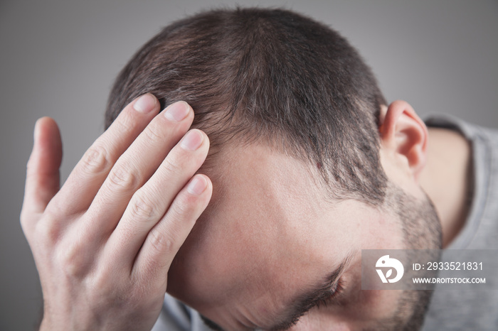 Caucasian man checking his hair. Hair loss problem