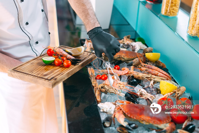 The Chef puts the seafood on a tray in the restaurant.