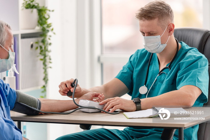 Therapist measuring blood pressure of patient