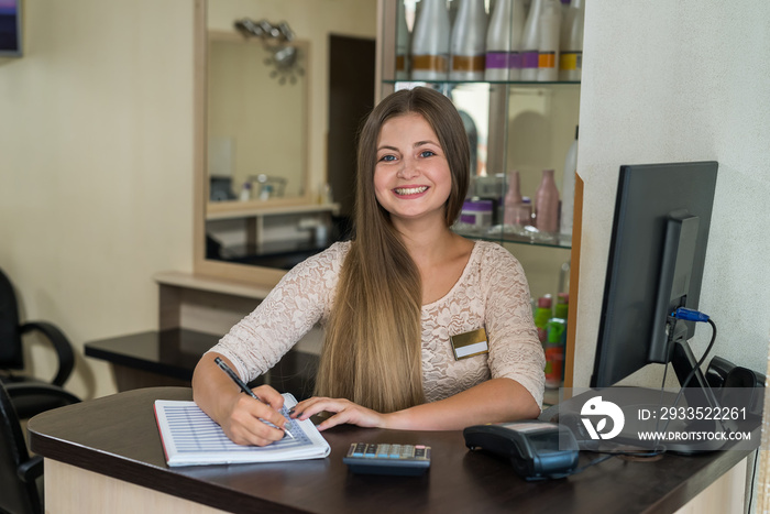 The beauty salon administrator is recording clients