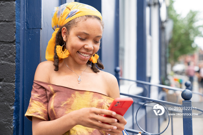 Young woman using smart phone in city