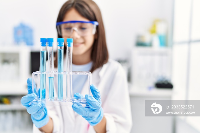 Young hispanic girl working at laboratory