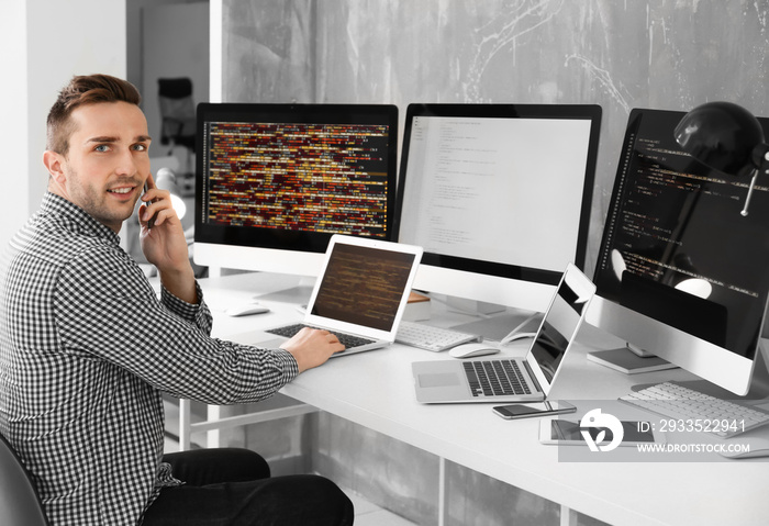 Handsome young programmer working in office