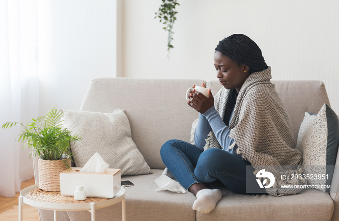 Sick Black Girl Drinking Hot Tea On Sofa At Home