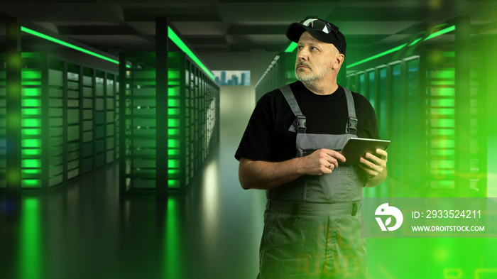 Man serving data center. Guy with tablet in server room. Man in server room. Man system administrator. Servers glowing green neon. Ensuring health of data center. Hosting company system administrator