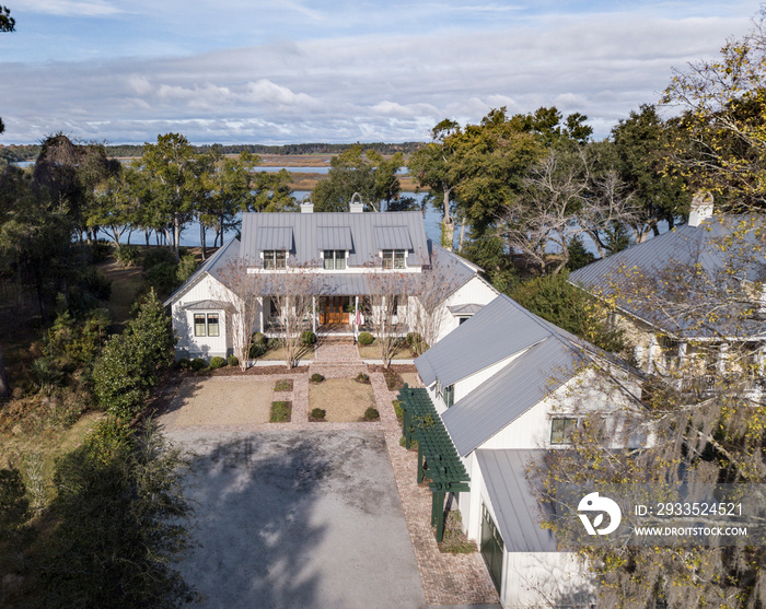 Beautiful, expensive large home on wooded waterfront lot, aerial view.