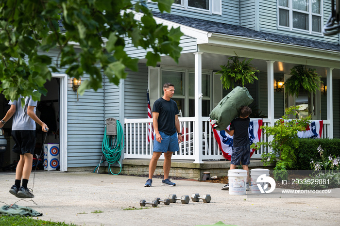 Air Force service member trains with his sons in a morning workout in preperation for a PT fitness test.