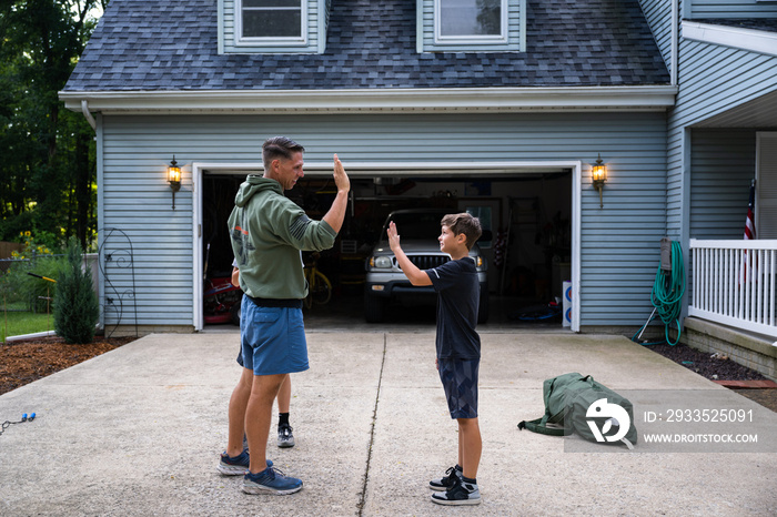 Air Force service member trains with his sons in a morning workout in preperation for a PT fitness test.