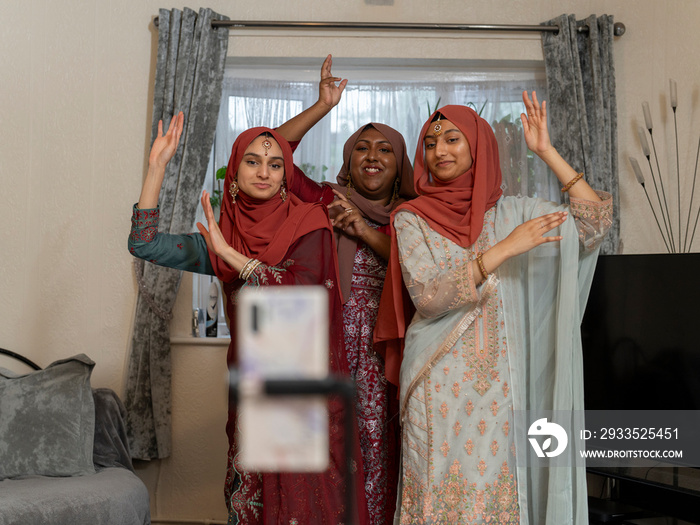 Women posing for picture during Ramadan celebration at home