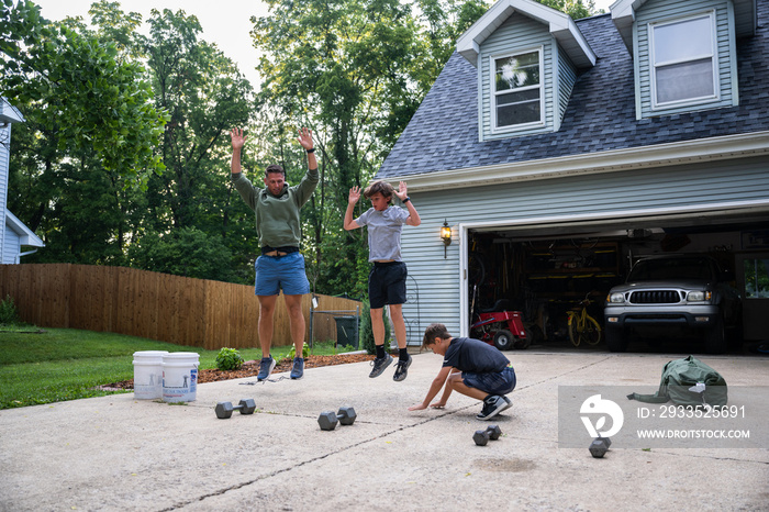 Air Force service member trains with his sons in a morning workout in preperation for a PT fitness test.