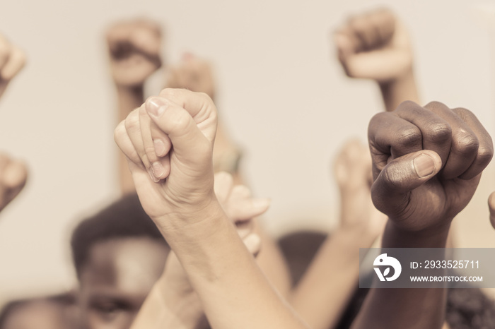 People raised fist air fighting for their rights. Labor movement, election movement, no racism and union concept. Image