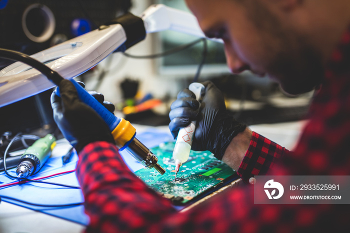 IT engineer technician repairing computer in electronics service shop