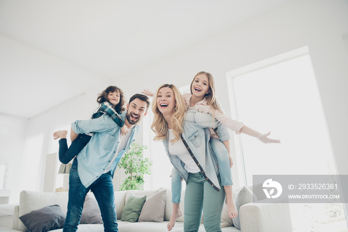 Photo of four family members having best free time hands like wings airplane flight indoors apartments