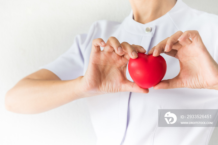 Female nurse is holding a red heart shape. Health, Insurance and love concept