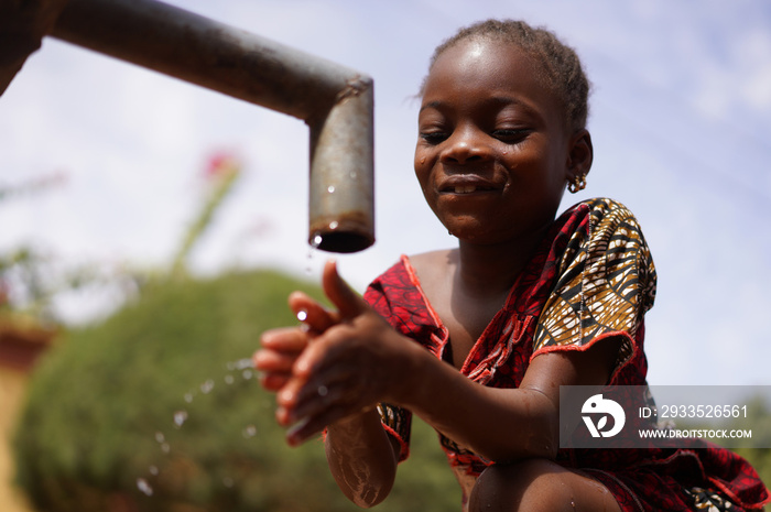 Cheerful Little African School Girl Drinks Safe Drinkable Fresh Clean Water from Home Tap