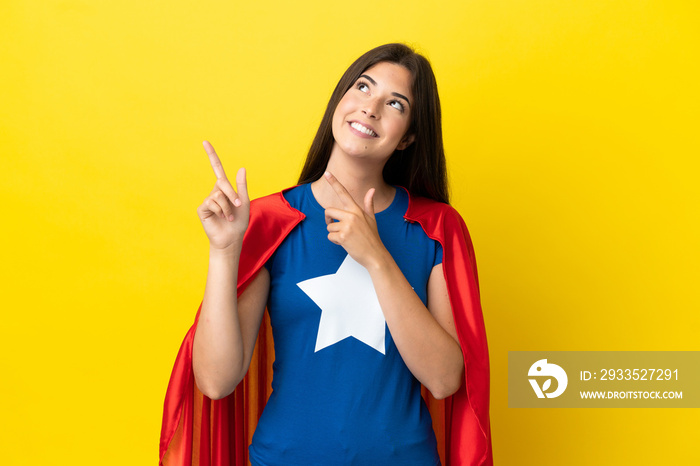 Super Hero Brazilian woman isolated on yellow background pointing with the index finger a great idea