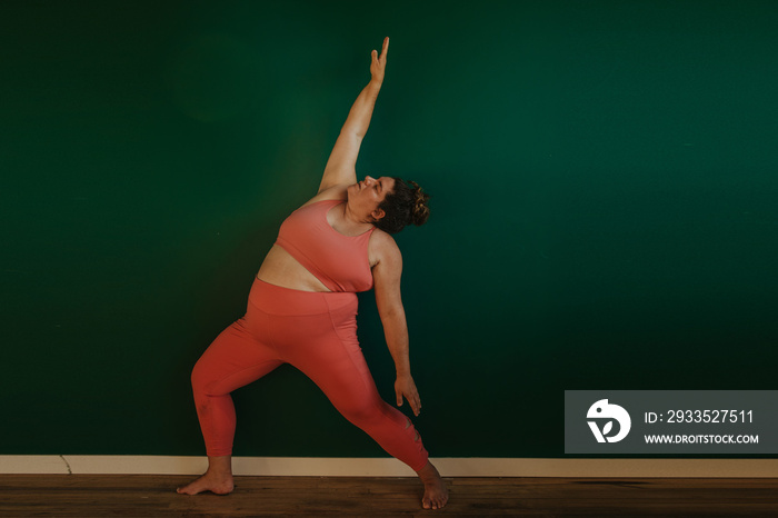 plus size woman does yoga pose