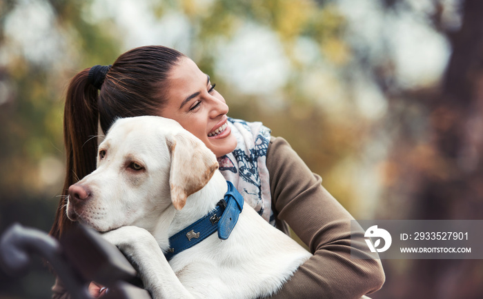 Young woman with a dog in the park. Pets and animals concept