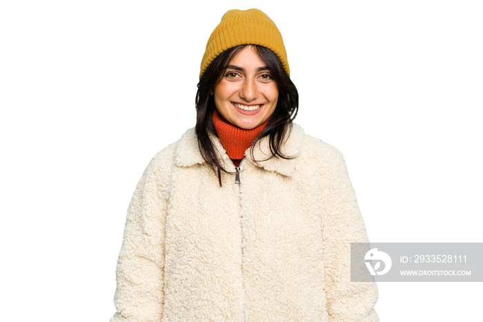 Young Indian woman wearing winter jacket and a wool cap isolated happy, smiling and cheerful.