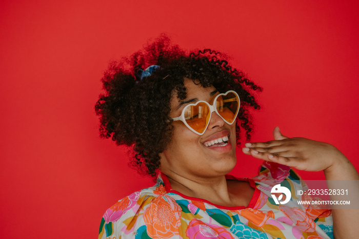 closeup of a plus size black person with heart sunglasses