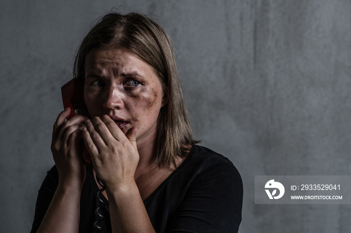 Scared  woman victim of domestic violence and abuse asks for help by phone. Looking away. Empty space for text