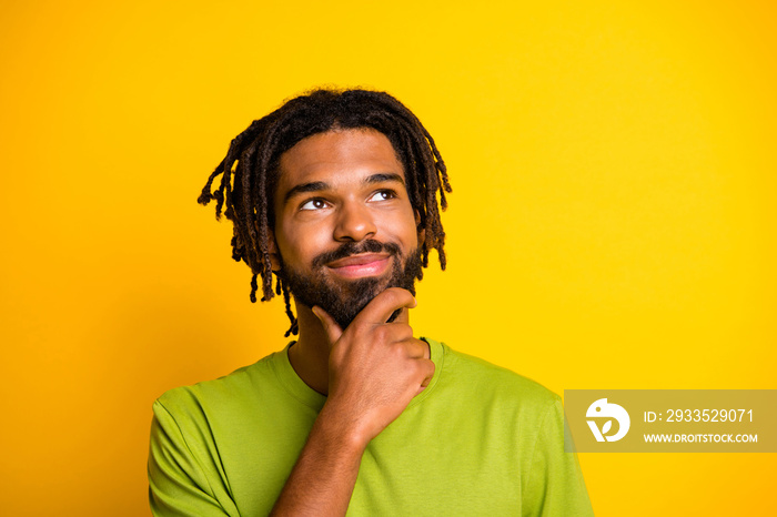 Photo of minded dark skin guy look empty space touch chin face think isolated over shine color background