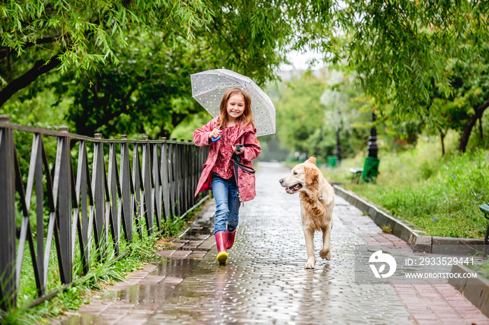 Little girl walking under rain with dog