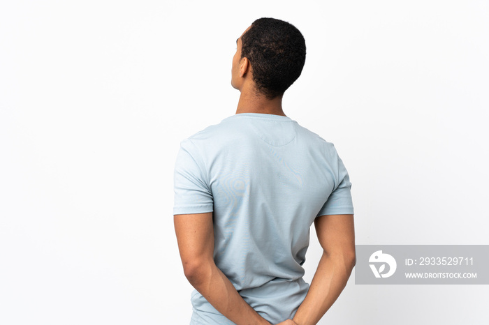 African American man over isolated white background in back position and looking back