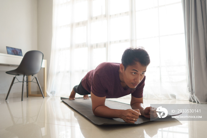 asian man doing workout sport plank at home