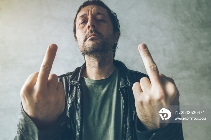 Angry male punk showing middle finger