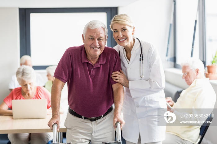 Nurse helping senior with walking aid