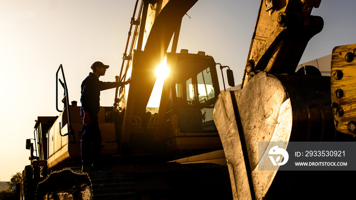 A contractor builder is sitting near bulldozer