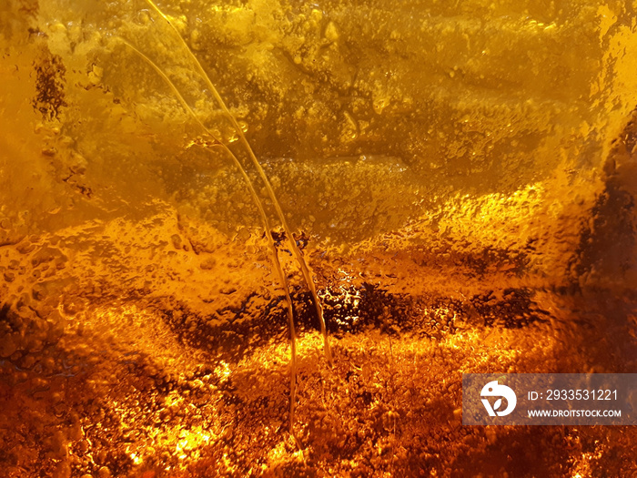 Thick glass of beautiful amber-orange color close-up