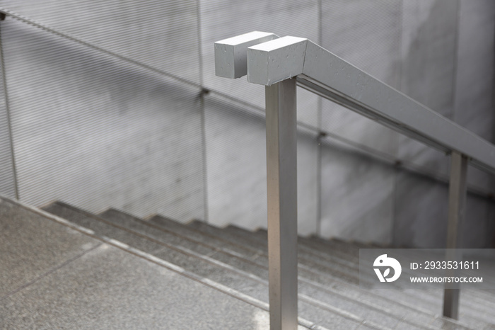 Close up of wet stainless steel railings pathway to tunnel.