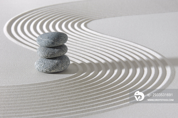 Japanese ZEN garden with stacked rocks in white textured sand