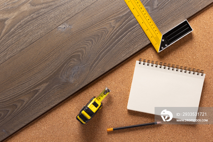 Wood laminate and tools on floor background texture. Wooden laminate