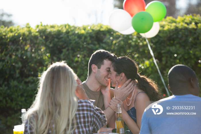 Male soldier kissing wife at homecoming party