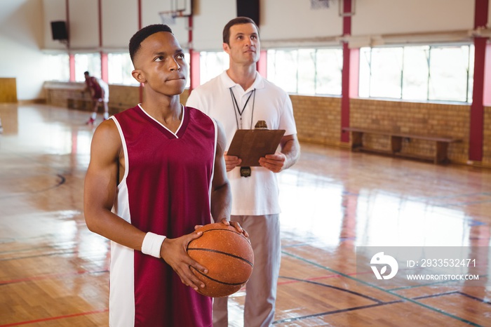 Thoughtful basketball player with coach