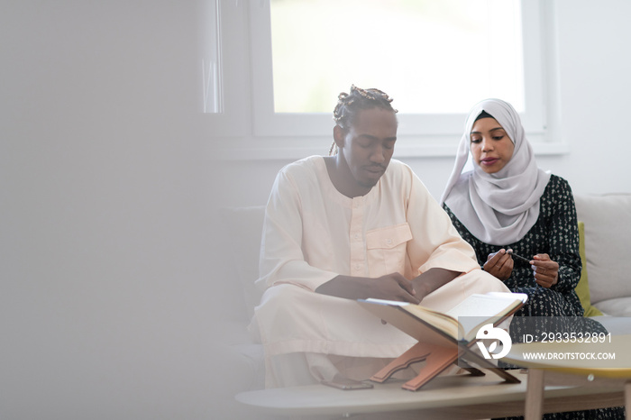 african couple at home reading quaran