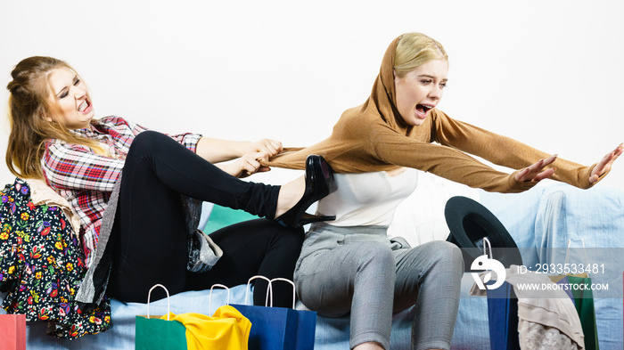 Two women arguing over sweater