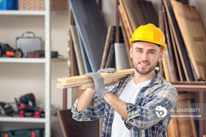 Handsome young carpenter in workshop