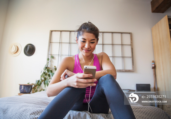 Young woman listening to music on smart phone