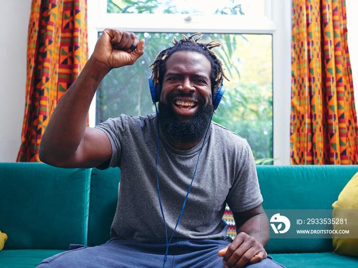 Portrait of man listening to music on headphones