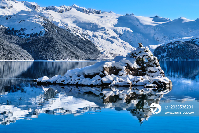 Mountain lake little island snow winter reflections.  Garibaldi Lake. Whistler. British Columbia. Canada