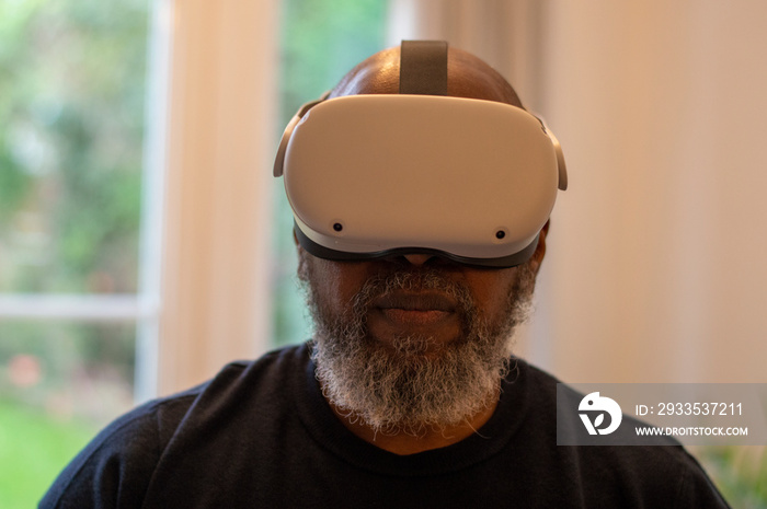 Mature man wearing VR headset