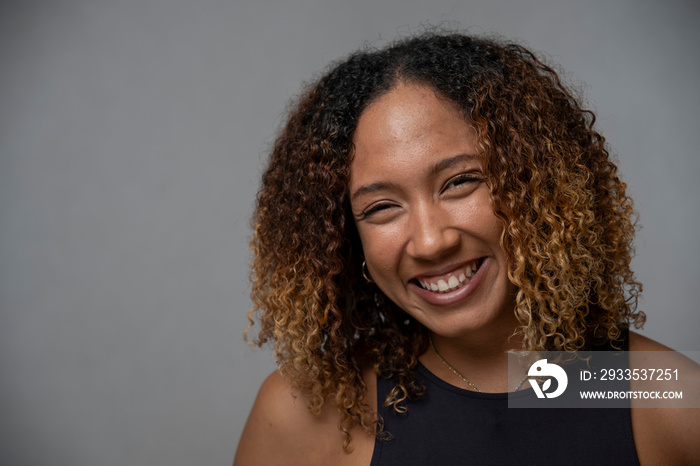 Portrait of smiling woman with curly hair