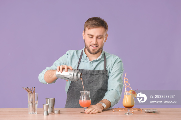 Male bartender making cocktail against color background