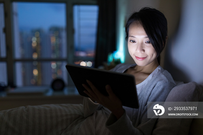 Woman using digital tablet at home