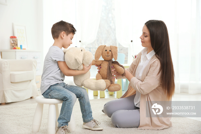 Young child psychologist working with little boy